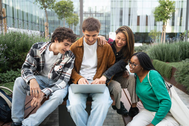 Group of university students using laptop working and learning together discussing about University project
